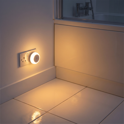 Petty Pet DuskSense automatic amber night light in a UK bathroom at night